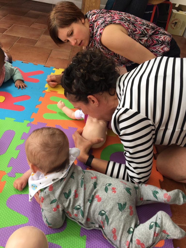 Mother performing CPR on a dummy