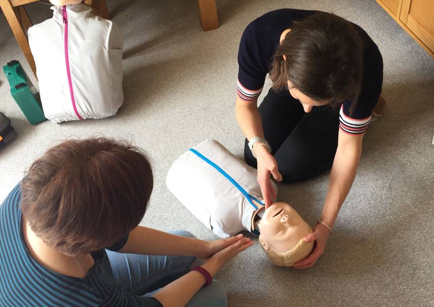 Woman clears airways on CPR dummy
